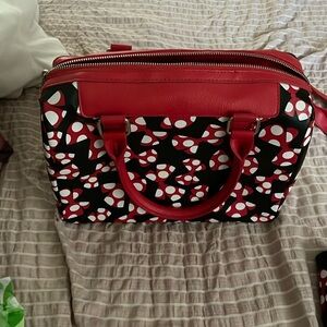 Disney’s Minnie mouse purse. Has one strap and has pocket on the inside